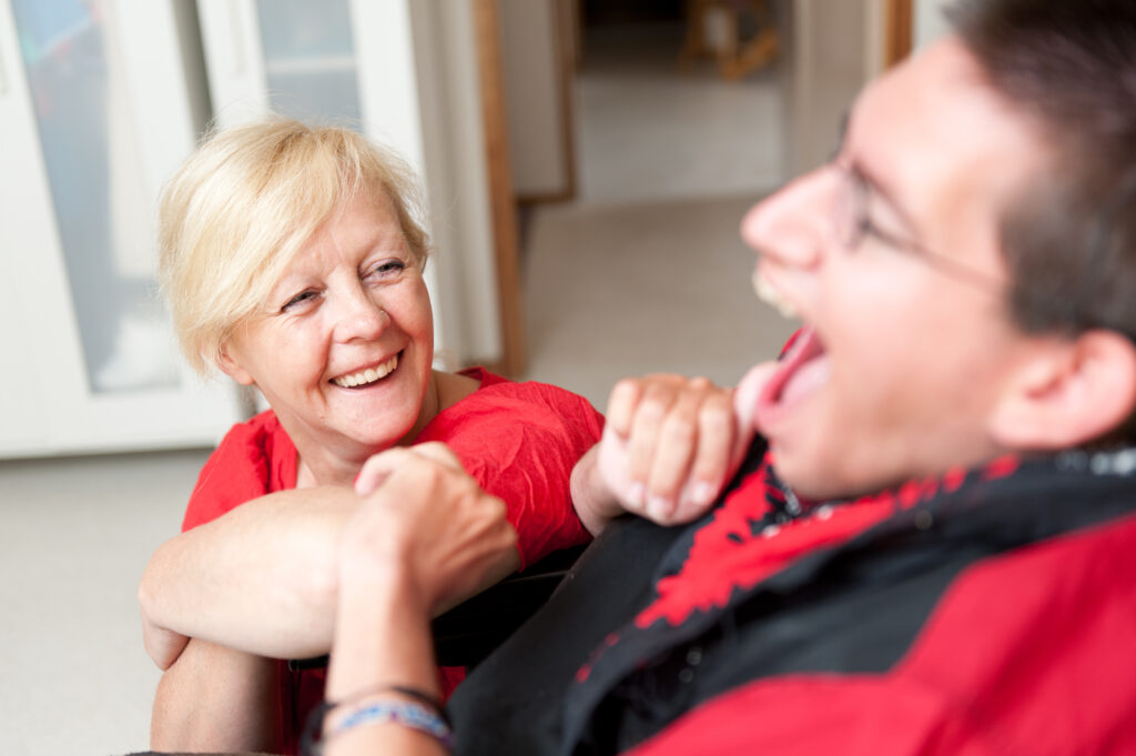 Disability Support Worker looking up at a Man.